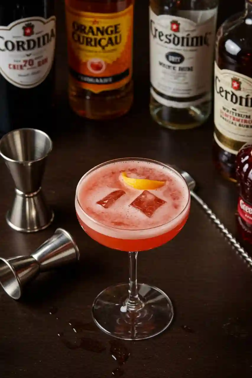 el-presidente-cocktail-ingredients.webP Neatly arranged El Presidente ingredients on dark wood